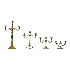Vintage brass 3-prong candelabras with varied heights and patina finishes, styled for event tablescape