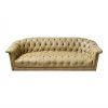 Pale yellow leather vintage sofa with tufted seat and curved arms.