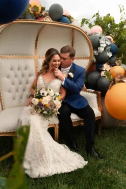 Tia Settee throne chair in styled wedding photo shoot with florals and greenery