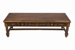Adiago vintage wood coffee table with carved apron detail and turned legs, front three-quarter view