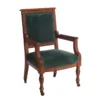 Blythe Chair in hunter green velvet with ornate carved dark wood frame and caster legs, front view