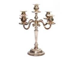 Vintage mismatched silver 5-prong candelabras with varied finishes and silhouettes, styled for formal event setting