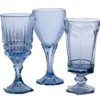 Mismatched vintage light blue glass goblets in varying sizes and patterns, styled table view