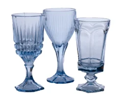Mismatched vintage light blue glass goblets in varying sizes and patterns, styled table view