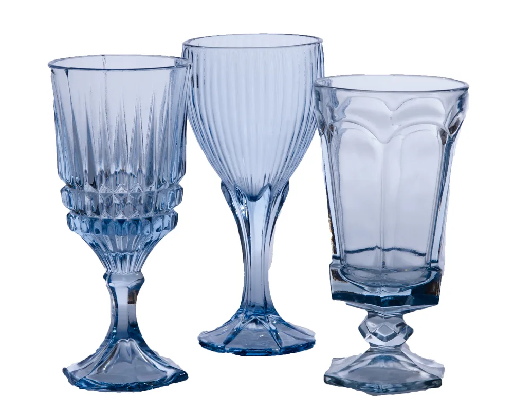 VioletVintage-459-1.jpg WEBP Mismatched vintage light blue glass goblets in varying sizes and patterns, styled table view