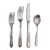 Vintage Silver Flatware — mismatched silver-toned vintage forks, knives, and spoons arranged on linen surface