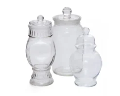 Frances Jar Set — three clear glass apothecary-style jars with lids in varying heights, grouped on white surface