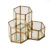 Gold geometric honeycomb lantern with faceted glass panels and angular metal frame, front view
