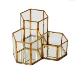 Gold geometric honeycomb lantern with faceted glass panels and angular metal frame, front view