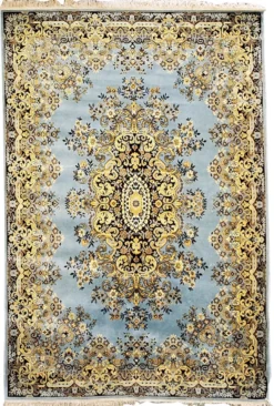 Oversized vintage area rug with a blue and yellow pattern and fringed edges
