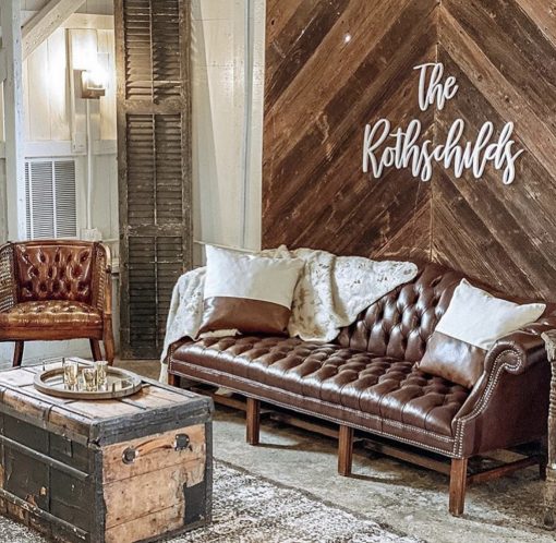 Leather sofa, leather chair, and a vintage trunk used in a lounge setting.