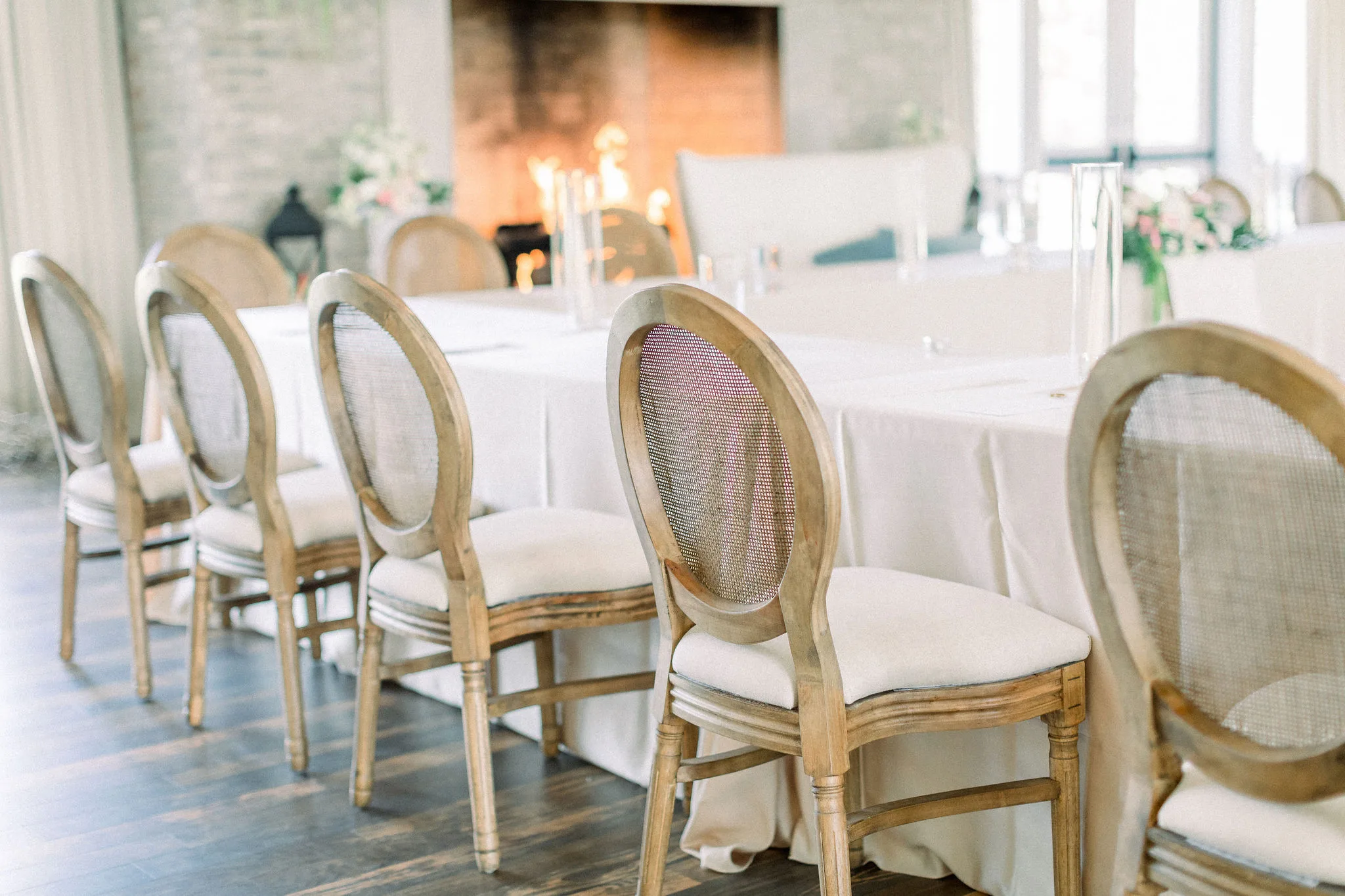 Louis French Chairs at kings table at reception WEBP Louis Cane Back Chair rental from Violet Vintage Rentals with an off white cushion around a table