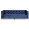 Midnight blue velvet sofa with mid-century modern charm, tufted on the seat and back, and silver legs.