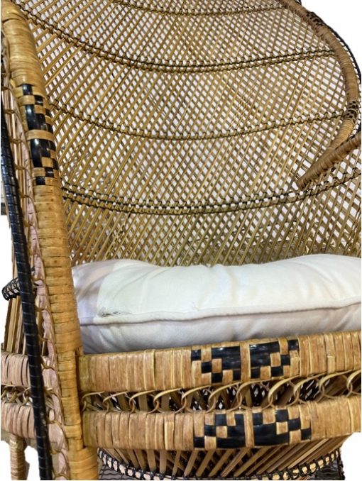 Close up on rattan peacock chair showing black geometric details within the rattan seat edging.