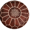 Brown leather ottoman with white detailing. Top view shows a medallion in the middle with spokes radiating around it to create a symmetrical design