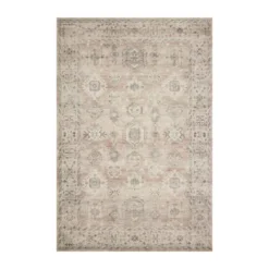 Area rug with soft pink dues in the small repeating medallion deisgn.