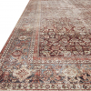 Close up of Layla rug with ornate designs in maroon, blue, beige, and rust.