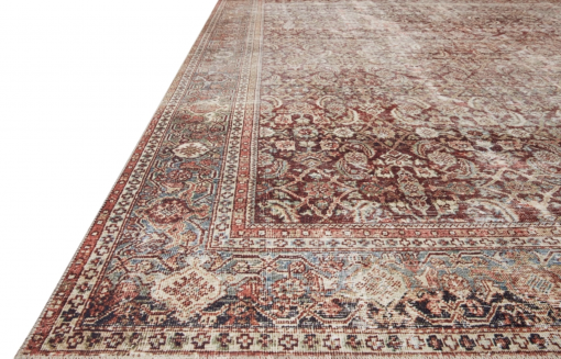 Close up of Layla rug with ornate designs in maroon, blue, beige, and rust.