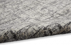 Close up view of rug with off white backdrop and gray lines