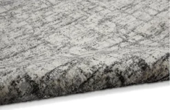 Close up view of rug with off white backdrop and gray lines