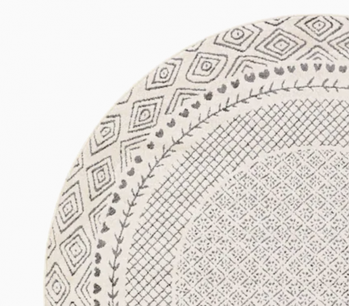 Round cream rug with gray detailing - diamonds for the border, tiny hearts, and lines.