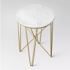 View of Juno side table from a higher view - showcasing the white marble table top and gold criss-crossed legs