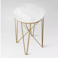 View of Juno side table from a higher view - showcasing the white marble table top and gold criss-crossed legs