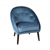 Blue velvet upholstered chair with tufted round back that tapers through the arms