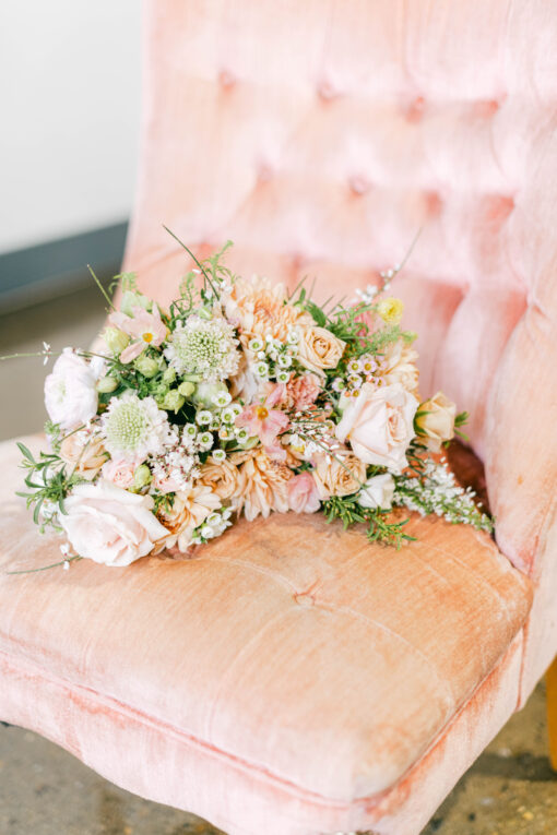 Velvet pink chair with no arms with a floral bouquet