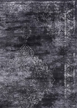 Close up on dark gray rug with faded white medallion and border