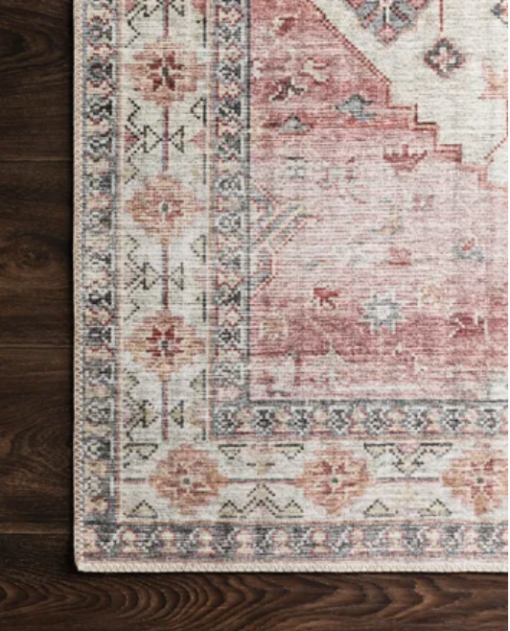 arial view of corner of rug with soft pinks and ivory