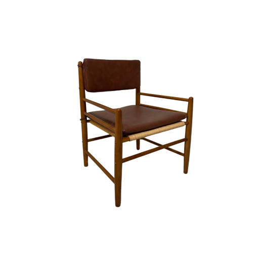 Light wood chair with faux leather cushions on seat and back.