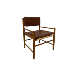 Light wood chair with faux leather cushions on seat and back.