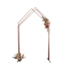 Three copper pipes attached to solid legs on the bottom and meeting at the top in an angle.