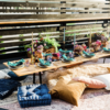 Colorful pillows and cushions on a variety of rugs around a low long table with beautiful tablescape