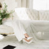 Sofa with close up with bride sitting on it.