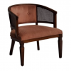 Dark dusty pink barrel chair with velvet on seat and back. Cane on arms. Dark wood edging, around cane, and legs.