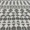 Gray and white rug with close up on the geometric triangles