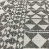 Border close up of the rug with shapes in gray and white