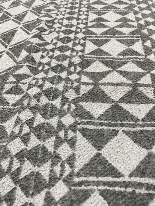 Border close up of the rug with shapes in gray and white