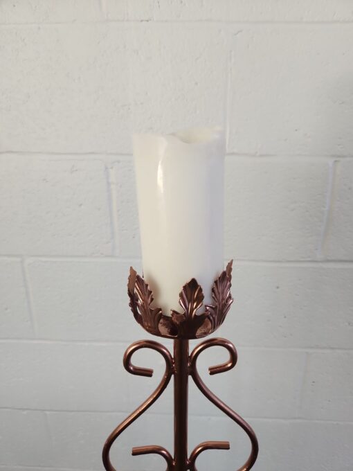 Top of the candle can hold up to a 3 inch pillar candle. Ornate design around the base.