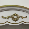 Close up on detail on the dresser. White background with gold design.