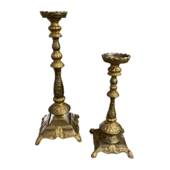 Giant gold candlesticks in various sizes. Thick base with legs, ornate stick and wide top to hold a pillar candle.