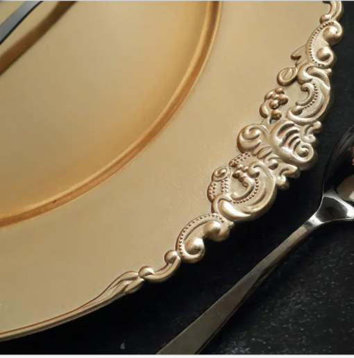 Ornate detailing on edge of gold charger, close up