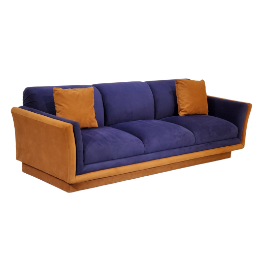 Side view of sofa. Tan on the side of the arm and along the base. Purple velvet on the cushions.