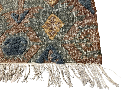 Edge of rug showing off white tassles