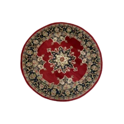 Ariel view of a round rug with navy flowered border and deep red inside. Navy and white medallion in the center.