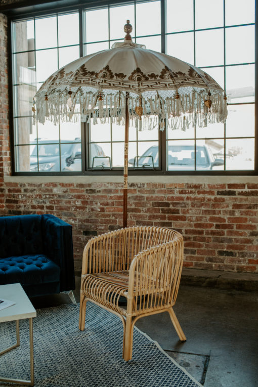 Decorative umbrella against an industrial window