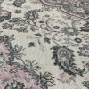 Close up detail of rug. Gray paisley on ivory base with pink.ay