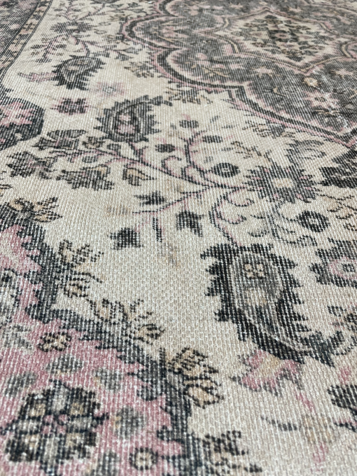 Close up detail of rug. Gray paisley on ivory base with pink.ay